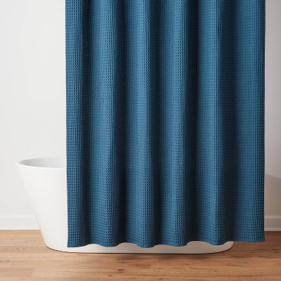 **Threshold Waffle Weave Shower Curtain** from Target takes our top spot for 2025 thanks to its perfect blend of style and practicality. Made from 100% cotton, this curtain